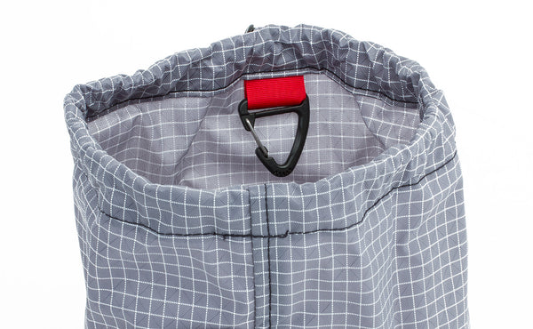 An image of the triangle clip, often used as a yarn guide, sewn into the top-interior seam of the Yarn Stuff Sack in Northwest Sky (light grey with white grid) 200 Halcyon.